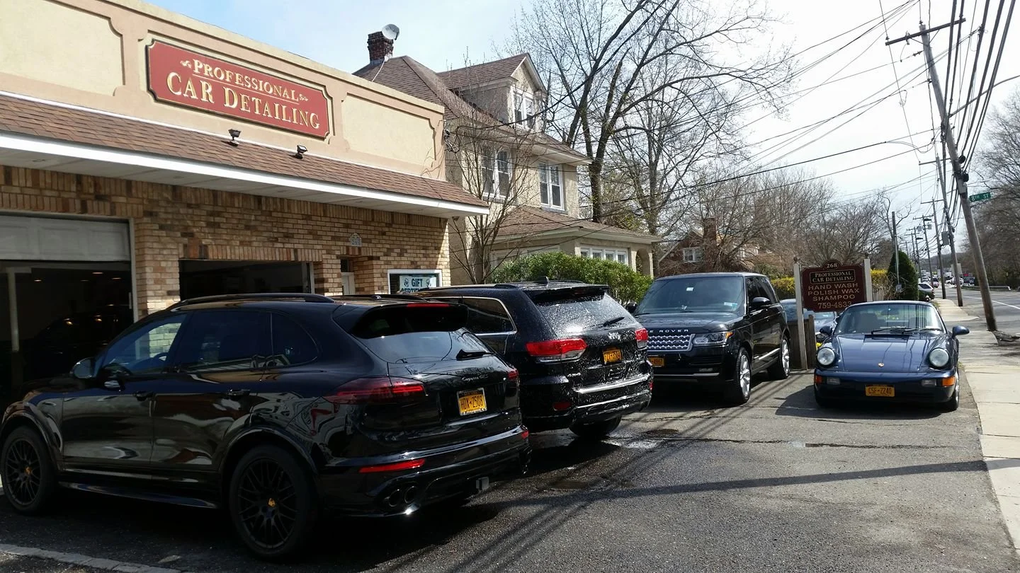 Four vehicles lined up outside Professional Car Detailing shop